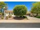 A cozy single-story home with lush landscaping, a tiled roof, and a two-car garage at 13134 W Los Bancos Ct, Sun City West, AZ 85375
