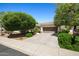 Charming single-story home with a well-maintained lawn, mature trees, and a two-car garage at 13134 W Los Bancos Ct, Sun City West, AZ 85375