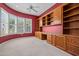 Bright home office features custom wood built-ins and shutters for ample light control at 13134 W Los Bancos Ct, Sun City West, AZ 85375