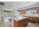 Open kitchen with island and a view of the living space with a carpeted floor at 13134 W Los Bancos Ct, Sun City West, AZ 85375