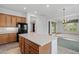 View of the kitchen and breakfast bar offering a cozy space for casual dining at 13134 W Los Bancos Ct, Sun City West, AZ 85375