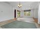 Bright living space with carpet flooring and sliding glass doors leading to backyard at 13134 W Los Bancos Ct, Sun City West, AZ 85375