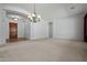 Open-concept living room with arched doorway and neutral carpet flooring at 13134 W Los Bancos Ct, Sun City West, AZ 85375