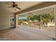 Inviting covered patio featuring a ceiling fan, water fountain, and beautifully landscaped backyard at 13134 W Los Bancos Ct, Sun City West, AZ 85375