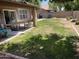Large backyard featuring a covered patio, a spacious lawn, and a fenced perimeter, perfect for outdoor activities at 1314 S Larkspur St, Gilbert, AZ 85296