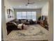 Spacious living room featuring vaulted ceilings, a comfortable L-shaped couch, and a decorative area rug at 1314 S Larkspur St, Gilbert, AZ 85296
