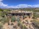 Stunning aerial view of a home with desert landscaping, a cozy patio, and scenic mountain views, perfect for outdoor living at 1401 E Boulder Pass Pass, Carefree, AZ 85377