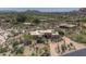 An aerial view showcases the property's desert landscape, including lush greenery and a circular driveway at 1401 E Boulder Pass Pass, Carefree, AZ 85377