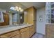 Bright bathroom with tile flooring, knotty alder cabinets, and a large mirror at 1401 E Boulder Pass Pass, Carefree, AZ 85377