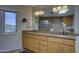 Bright bathroom features a dual sink vanity, a tile shower, and a large window to outdoors at 1401 E Boulder Pass Pass, Carefree, AZ 85377