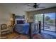 Spacious main bedroom featuring a ceiling fan, area rug, and sliding glass door to patio at 1401 E Boulder Pass Pass, Carefree, AZ 85377