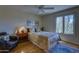 Comfortable bedroom with natural light, wood floors, ceiling fan, and desert views at 1401 E Boulder Pass Pass, Carefree, AZ 85377