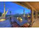 Relaxing covered patio with dining table, cacti and desert views, perfect for outdoor enjoyment at 1401 E Boulder Pass Pass, Carefree, AZ 85377
