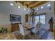 Elegant dining room with wood beam ceiling, chandelier, and ample natural light at 1401 E Boulder Pass Pass, Carefree, AZ 85377