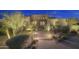 Inviting Southwestern-style home featuring desert landscaping, enhancing its curb appeal at dusk at 1401 E Boulder Pass Pass, Carefree, AZ 85377
