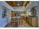 Eat-in kitchen offers a center island with seating, stainless appliances, and natural wood beam ceiling at 1401 E Boulder Pass Pass, Carefree, AZ 85377