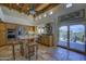 Bright kitchen features knotty alder cabinets, granite countertops, and stainless steel appliances at 1401 E Boulder Pass Pass, Carefree, AZ 85377