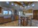 Open kitchen with island seating, stainless steel appliances, and a beamed ceiling at 1401 E Boulder Pass Pass, Carefree, AZ 85377