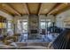 Cozy living room with stone fireplace, exposed wood beams, and access to the outdoors at 1401 E Boulder Pass Pass, Carefree, AZ 85377