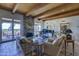 Bright living room featuring a stone fireplace, wood beam ceilings, and access to an outdoor patio at 1401 E Boulder Pass Pass, Carefree, AZ 85377