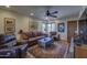 Spacious living room featuring plush leather seating, a ceiling fan, and a decorative area rug at 1401 E Boulder Pass Pass, Carefree, AZ 85377