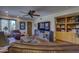 Cozy living room boasts custom built-ins, a ceiling fan, and comfortable leather seating at 1401 E Boulder Pass Pass, Carefree, AZ 85377