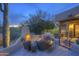 Inviting outdoor space with a cozy fireplace, built-in grill, and comfortable seating, perfect for relaxation at 1401 E Boulder Pass Pass, Carefree, AZ 85377