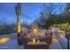 Inviting outdoor space with a cozy fireplace, built-in grill, and comfortable seating, perfect for relaxation at 1401 E Boulder Pass Pass, Carefree, AZ 85377
