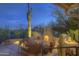 Inviting outdoor space with a cozy fireplace, built-in grill, and comfortable seating, perfect for relaxation at 1401 E Boulder Pass Pass, Carefree, AZ 85377