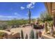 Inviting outdoor patio with desert landscaping, fireplace and comfortable seating, perfect for enjoying the Arizona weather at 1401 E Boulder Pass Pass, Carefree, AZ 85377