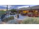 Expansive desert patio with outdoor fireplace, dining area, lounge, and desert views at 1401 E Boulder Pass Pass, Carefree, AZ 85377