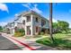 Charming multi-story home with a well-manicured lawn, beautiful landscaping, and a sunny sky at 15221 N Clubgate Dr # 2065, Scottsdale, AZ 85254
