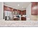Modern kitchen featuring stainless steel appliances, granite counters, and dark wood cabinetry at 15221 N Clubgate Dr # 2065, Scottsdale, AZ 85254