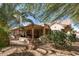 Large, landscaped backyard featuring a spacious covered patio, perfect for outdoor living and entertaining at 15797 W Cinnabar Dr, Surprise, AZ 85374