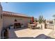 Expansive backyard patio with seating, dining area, and landscaped accents offers a perfect outdoor retreat at 15797 W Cinnabar Dr, Surprise, AZ 85374