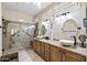 Elegant bathroom with double sinks, granite countertops, and a glass-enclosed shower at 15797 W Cinnabar Dr, Surprise, AZ 85374