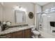 Clean bathroom with granite countertops, white vanity and a glass shower at 15797 W Cinnabar Dr, Surprise, AZ 85374