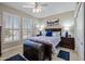 Comfortable bedroom with plantation shutters, trunk, and classic decor at 15797 W Cinnabar Dr, Surprise, AZ 85374