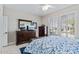 Bedroom with plantation shutters, tile flooring, and ensuite bathroom entrance at 15797 W Cinnabar Dr, Surprise, AZ 85374
