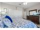 Relaxing bedroom featuring a large dresser, a ceiling fan, and a spacious closet at 15797 W Cinnabar Dr, Surprise, AZ 85374