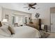 Bright bedroom with natural light from bay windows with seating and a ceiling fan at 15797 W Cinnabar Dr, Surprise, AZ 85374