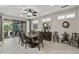Elegant dining room featuring a table with seating for six, a buffet, and sliding glass doors to the outdoor patio at 15797 W Cinnabar Dr, Surprise, AZ 85374