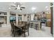Open concept dining room with modern lighting, built in shelving, and kitchen bar at 15797 W Cinnabar Dr, Surprise, AZ 85374