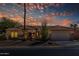 Charming single-story home with a tile roof, desert landscaping, and a welcoming curb appeal at sunset at 15797 W Cinnabar Dr, Surprise, AZ 85374