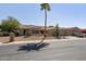 Charming single-story home features a red tile roof, desert landscaping, and a private front yard with a tall palm tree at 15797 W Cinnabar Dr, Surprise, AZ 85374