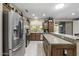 Spacious kitchen with stainless steel appliances, granite counters, and tile flooring at 15797 W Cinnabar Dr, Surprise, AZ 85374
