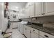 Functional laundry room with white cabinets and sink at 15797 W Cinnabar Dr, Surprise, AZ 85374