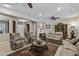 Spacious living room showcasing comfortable seating, a ceiling fan, and a well-lit interior, perfect for relaxation and gatherings at 15797 W Cinnabar Dr, Surprise, AZ 85374