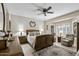 Cozy main bedroom with neutral colors, a ceiling fan, and large bay windows at 15797 W Cinnabar Dr, Surprise, AZ 85374