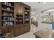 Office features a built-in bookcase with dark wood and tan walls, adding style and functionality to the workspace at 15797 W Cinnabar Dr, Surprise, AZ 85374